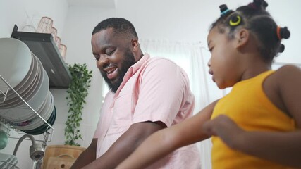 Wall Mural - 4K African father teaching little daughter washing dishes in the sink on kitchen counter with talking together after having dinner. Happy family dad and child girl kid spending time together at home.