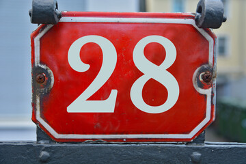 Wall Mural - A red number plaque, showing the number twenty-eight, 28
