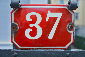 Wall Mural - A red number plaque, showing the number thirty-seven, 37