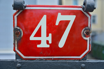 Wall Mural - A red number plaque, showing the number forty-seven, 47