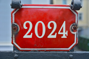 Wall Mural - A red house number plaque, showing the two thousand twenty four (2024) 