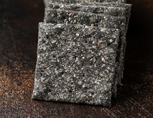 Wall Mural - Black Rye Sourdough Crispbread, crackers on rustic table