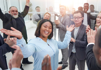 Successful business team celebrating with arms up