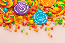 Colorful Lollipops And Round Candies On Pink Background. Top View.