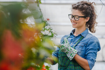 Young woman entrepreneur working in a flower garden