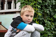 © Наталья Жукова - boy sits on a wooden porch in the village in summer