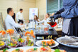 © davit85 - A young waiter pours drinks for catering.