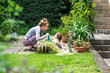 © Alexander - young mother and her toddler child are doing garden work with a watering can