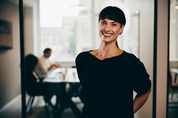 Smiling businesswoman standing in an office