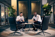 © Flamingo Images - Businessmen meeting in an office lounge
