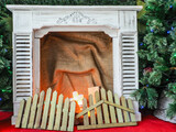 Fototapeta  - Imitation of a cozy fireplace for the New Year holidays - Christmas and New Year