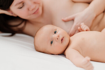 Wall Mural - breastfeeding. the baby lies next to the mother after feeding