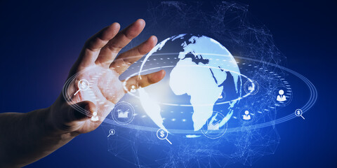 Poster - Close up of businessman hand holding glowing social globe hologram on blue background. Information, data and communication concept.