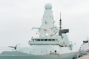 warship with many locators gun turret have arrived in harbour. naval. defence. protection. army. con