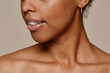 Close up portrait of young African-American woman demonstrating beautiful natural skin and white teeth smile, copy space