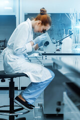 professional female scientist is working on a vaccine in a scientific research laboratory. genetic e