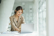 © PaeGAG - Asian woman working on a laptop computer,Working in the office with laptop concept,Young Asian woman starting a business using a laptop computer.