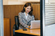 © PaeGAG - Asian woman working on a laptop computer,Working in the office with laptop concept,Young Asian woman starting a business using a laptop computer.