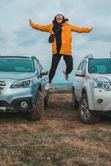 Poster - young stylish woman portrait in front of off road suv car