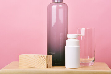 Wall Mural - Cosmetic bottle container on pink background, Blank label for branding mock-up.