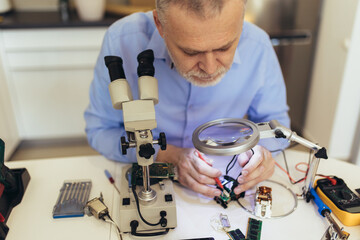 Engineer fixing broken computer equipment. Electronic repair shop, technology development concept