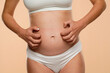 © vladimirfloyd - Cropped view of pregnant woman scratching  her belly