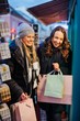 © Westend61 - Friends window shopping at Christmas Market