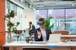 © Westend61 - Employee with VR googles gesturing in office