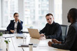 © Seventyfour - High angle portrait of successful businesswoman using wheelchair while leading business meeting in office with diverse group of people