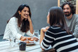 © Westend61 - Smiling businesswoman and colleagues having brunch at office cafeteria