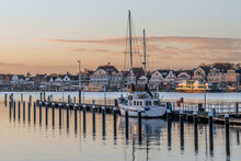 Germany, Schleswig-Holstein, Lubeck, Yacht Moored In Harbor At Dusk