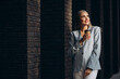 © Petro - Business woman drinking coffee by the office center