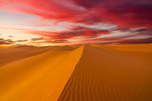 Sunset Over The Sand Dunes In The Desert. Arid Landscape Of The Sahara Desert.
