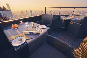 Sticker - Table setting on roof top restaurant with megapolis view, Bangkok Thailand.