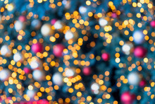Christmas Tree Light And Bauble Colorful Bokeh Background. Holiday Blur Decoration