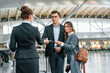 © standret - Giving the documents. Young couple is in the airport together