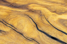 Close-up Of A Cut And Dried Piece Of Old Olive Tree. Wooden Texture, Pattern Of Old Tree