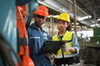 © FotoArtist - Portrait of Professional Heavy Industry Engineer / Worker Wearing Safety Uniform, Goggles and Hard Hat. In the Background Unfocused Large Industrial Factory