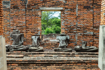 Aytthaya, Thailand, 22 Aug 2020 : Ancient old buddha statue sculpture is damaged at the old temple in Ayuthaya province, thailand. Selective focus.