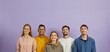 © Studio Romantic - Group of happy joyful smiling young multiethnic Caucasian and mixed race Indian African people wearing hoodies and sweatshirts standing on purple background, looking up, thinking about something good