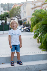 Canvas Print - Cute toddler boy, standing on stairs in the center of Monaco, smiling