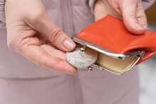 A Woman Takes Out A Silver American Dollar Of 1883 From A Red Vintage Wallet. Last Money