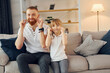 © standret - Learning to talk some words. Father with his little daughter is at home together
