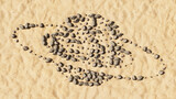 Fototapeta Przestrzenne - Concept conceptual stones on beach sand handmade symbol shape, golden sandy background, internet icon. 3d illustration metaphor for communication, technology, network, connection, travel and business