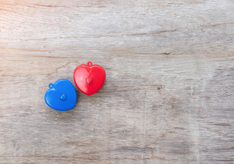 Blue and red heart on wooden desk concept of valentine 's day.