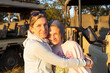 © Mint Images - A mother embracing her teenage daughter on a family safari vacation.