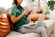 © (JLco) Julia Amaral - Young woman surfing the net at home