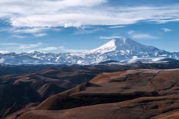 Wall Mural - Great nature mountain range. Amazing perspective of  Elbrus with autumn fields, blue sky background.