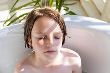 Eight Year Old Boy In A Bathtub