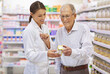 © Yuri Arcurs/peopleimages.com - Taking the questions out of medication. Shot of a young pharmacist helping an elderly customer.